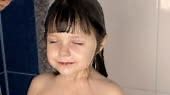 Child in the bathroom. Beautiful little girl in the shower in a...