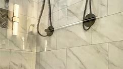 Dual Shower heads and frameless shower doors, plus a custom tiled nook and custom bench are gorgeous highlights in this walk in shower and bathroom remodel | Modern Blu