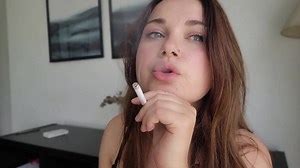 Smoking Fetish. Blue-eyed Cute Girl Smokes and looks you in the Eye
