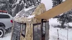 TENT CAMP WITH STOVE IN HEAVY SNOW.