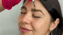 Eyebrow female master making correction and eyebrow tinting of client in beauty salon. Woman face portrait close up. Cosmetology procedure and treatment on vertical video